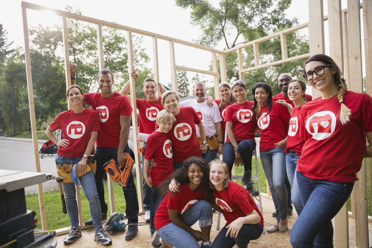 Image of a group of diverse adults and children volunteering