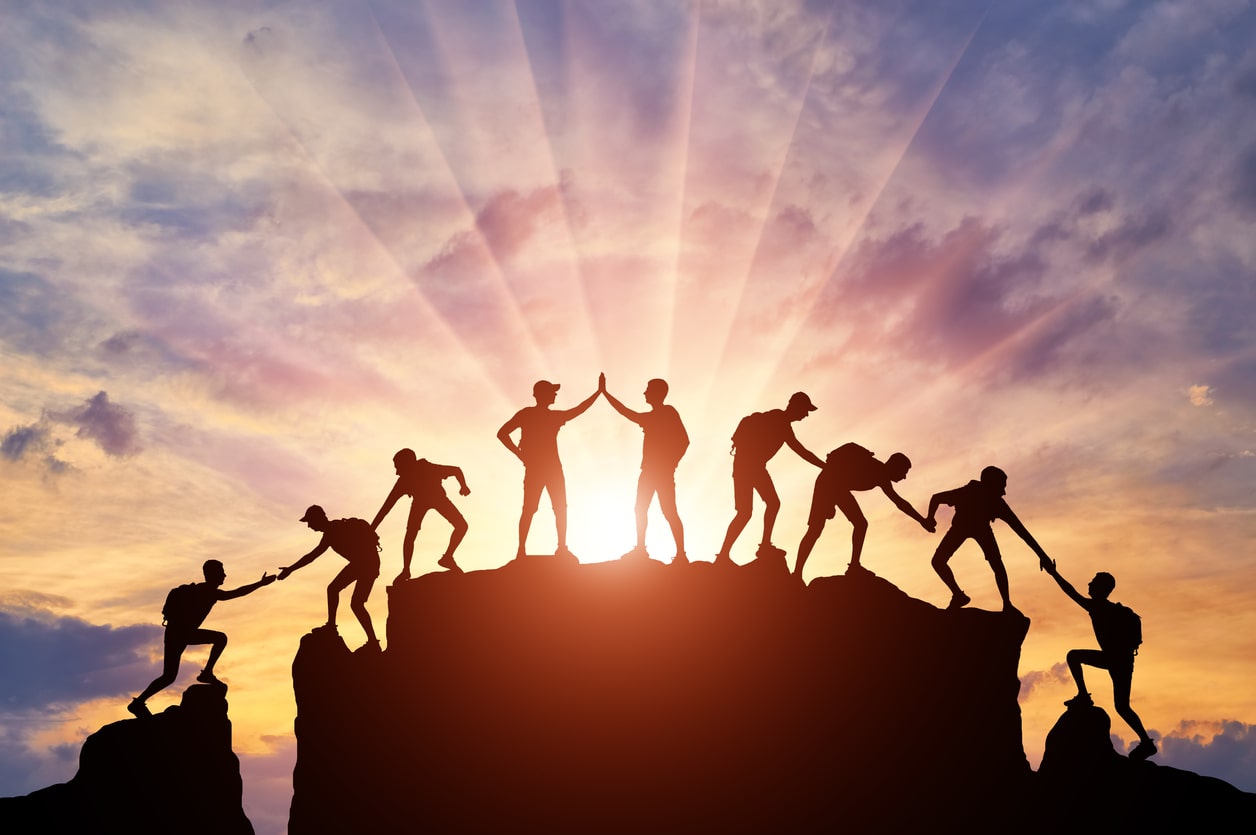 Visual of group of people working together to overcome an obstacle