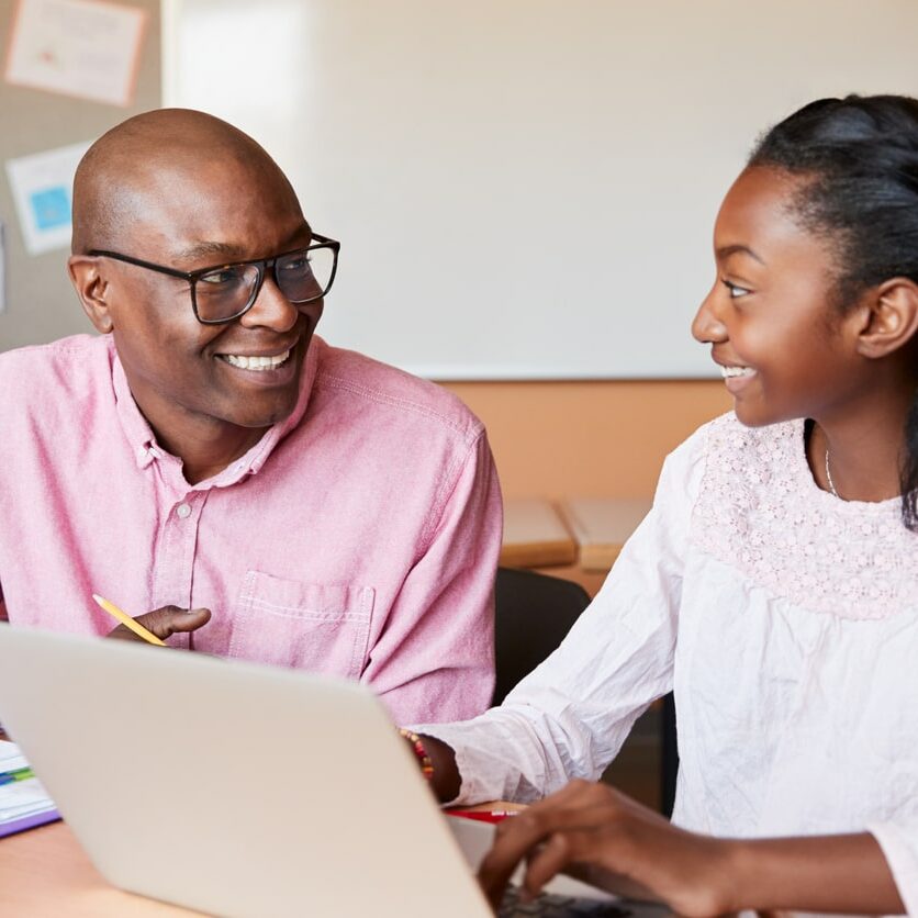 Visual of a man tutoring a teen